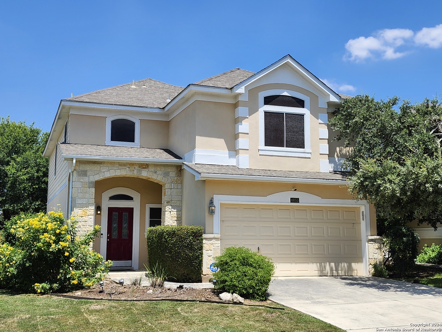 a front view of a house with garden