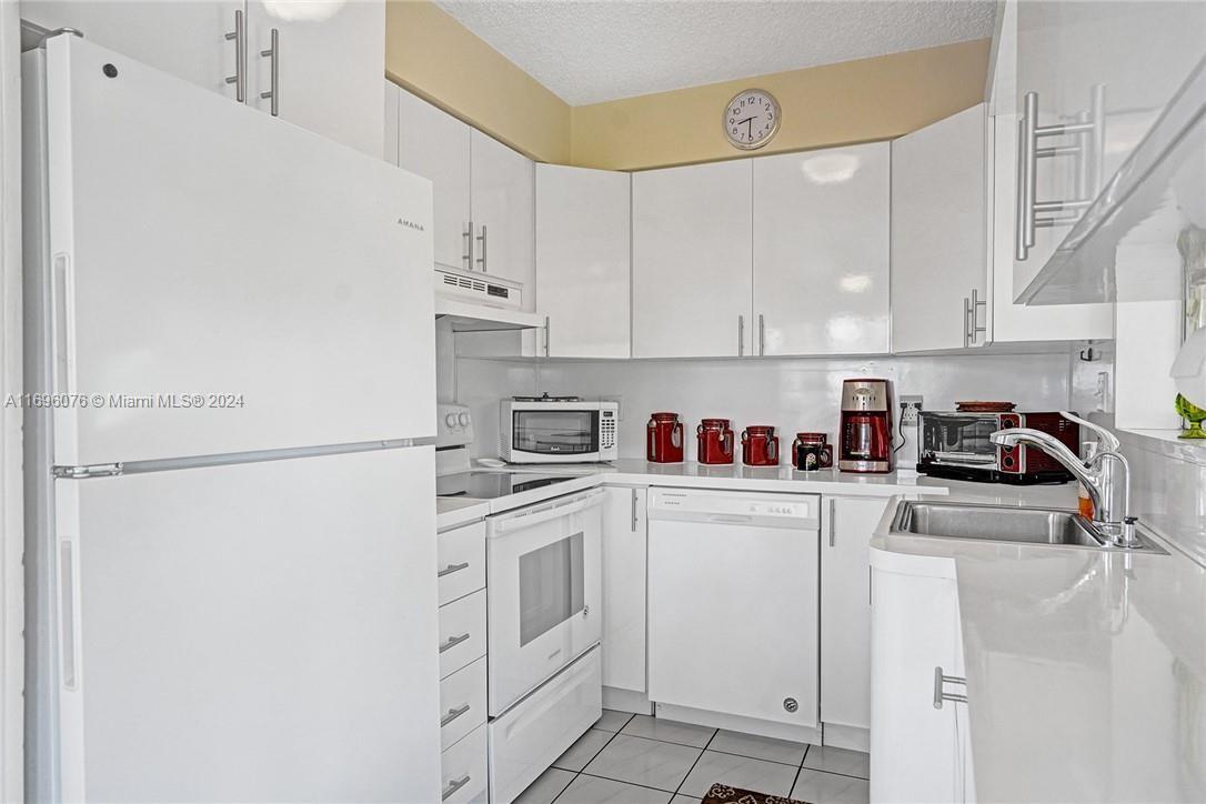 a white refrigerator freezer sitting inside of a kitchen