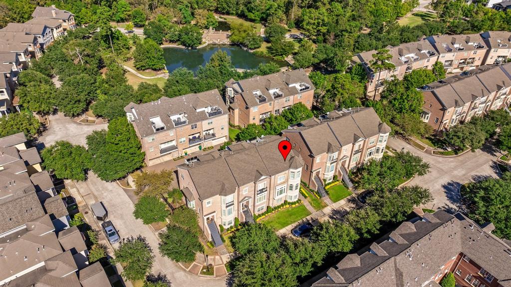 an aerial view of a house with a yard and outdoor seating