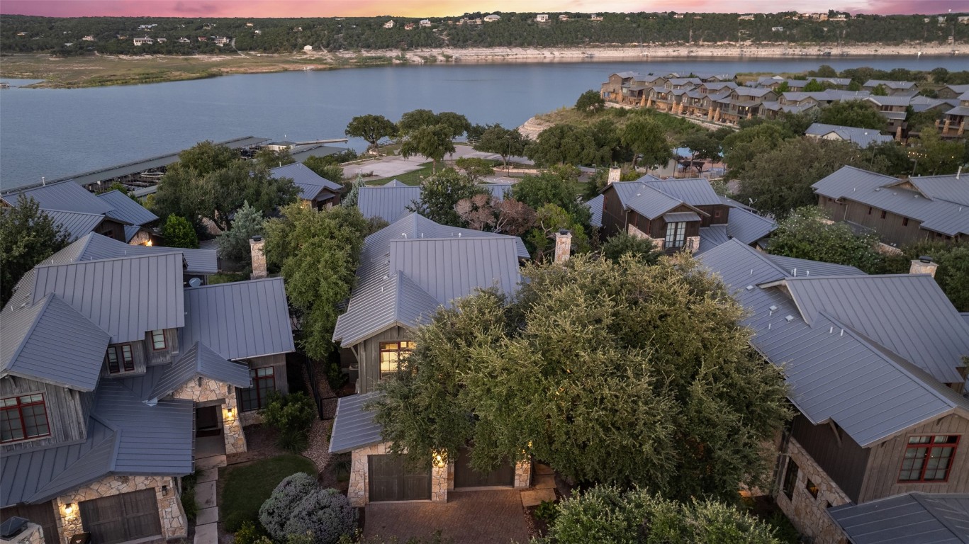 Welcome to your light-filled cliffside cottage in The Reserve at Lake Travis. Nestled on a picturesque street, the home overlooks the rolling hills and glimmering Lake Travis water.