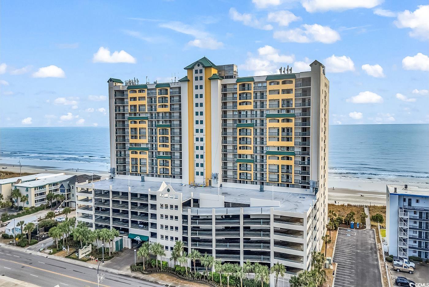 View of property with a water view and a view of t