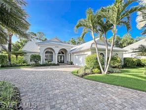 View of front of house with a front yard and a garage