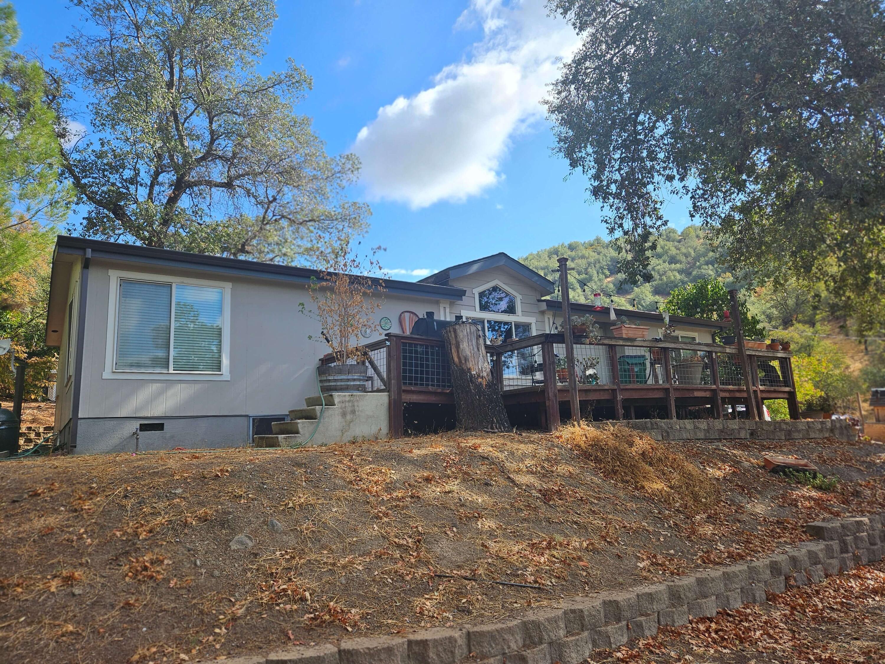 a view of a house with a yard covered in snow