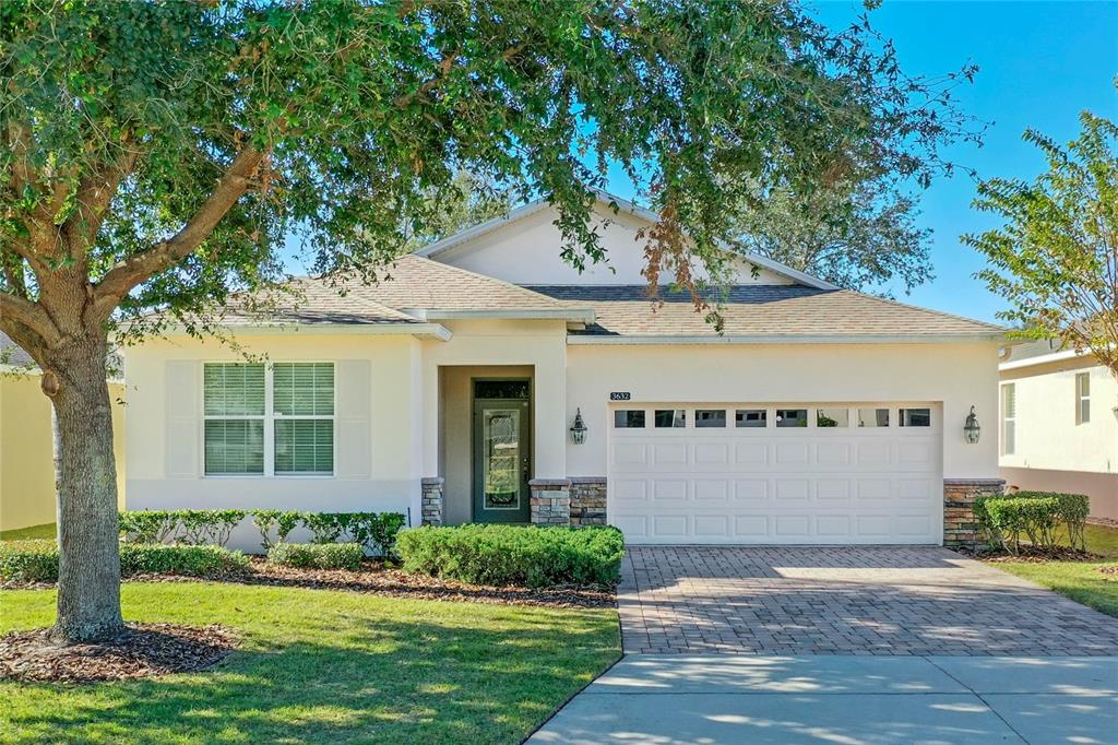 a front view of a house with a yard and garage