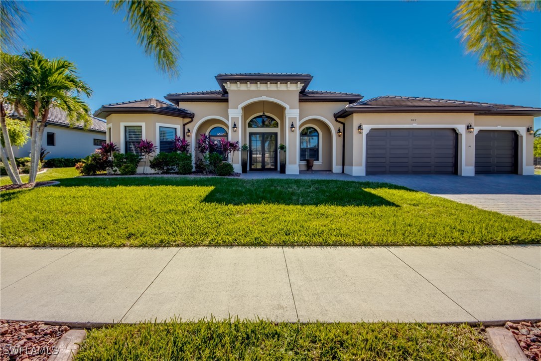 a front view of a house with a yard and garage