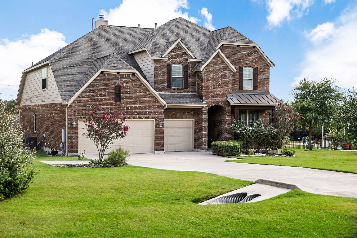 a front view of a house with a yard and garage