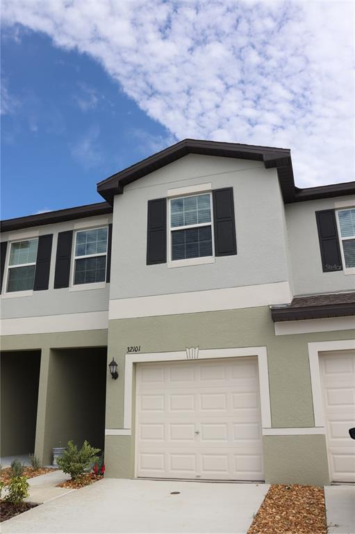 a front view of a house with garage