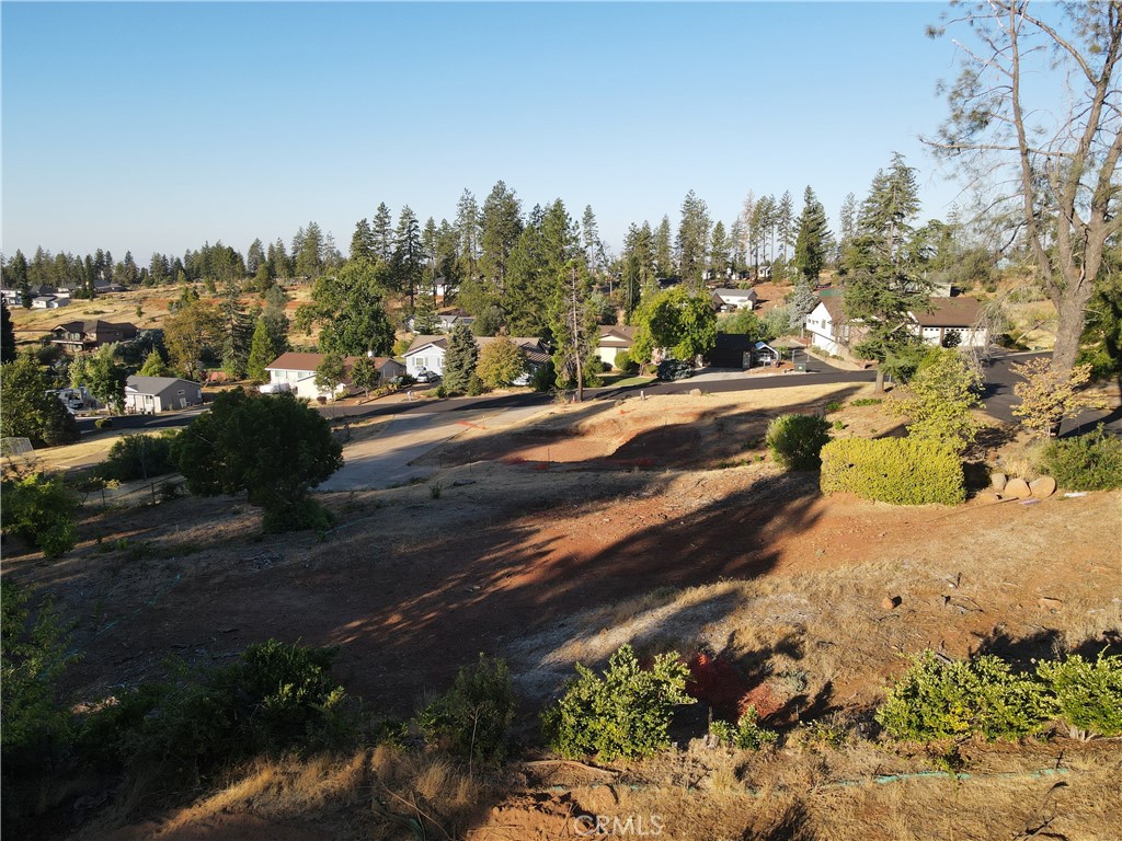 a view of a yard with wooden fence