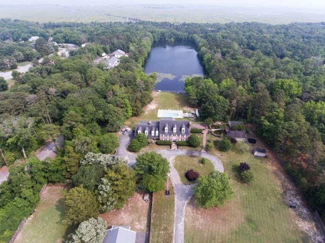 an aerial view of a house with a yard