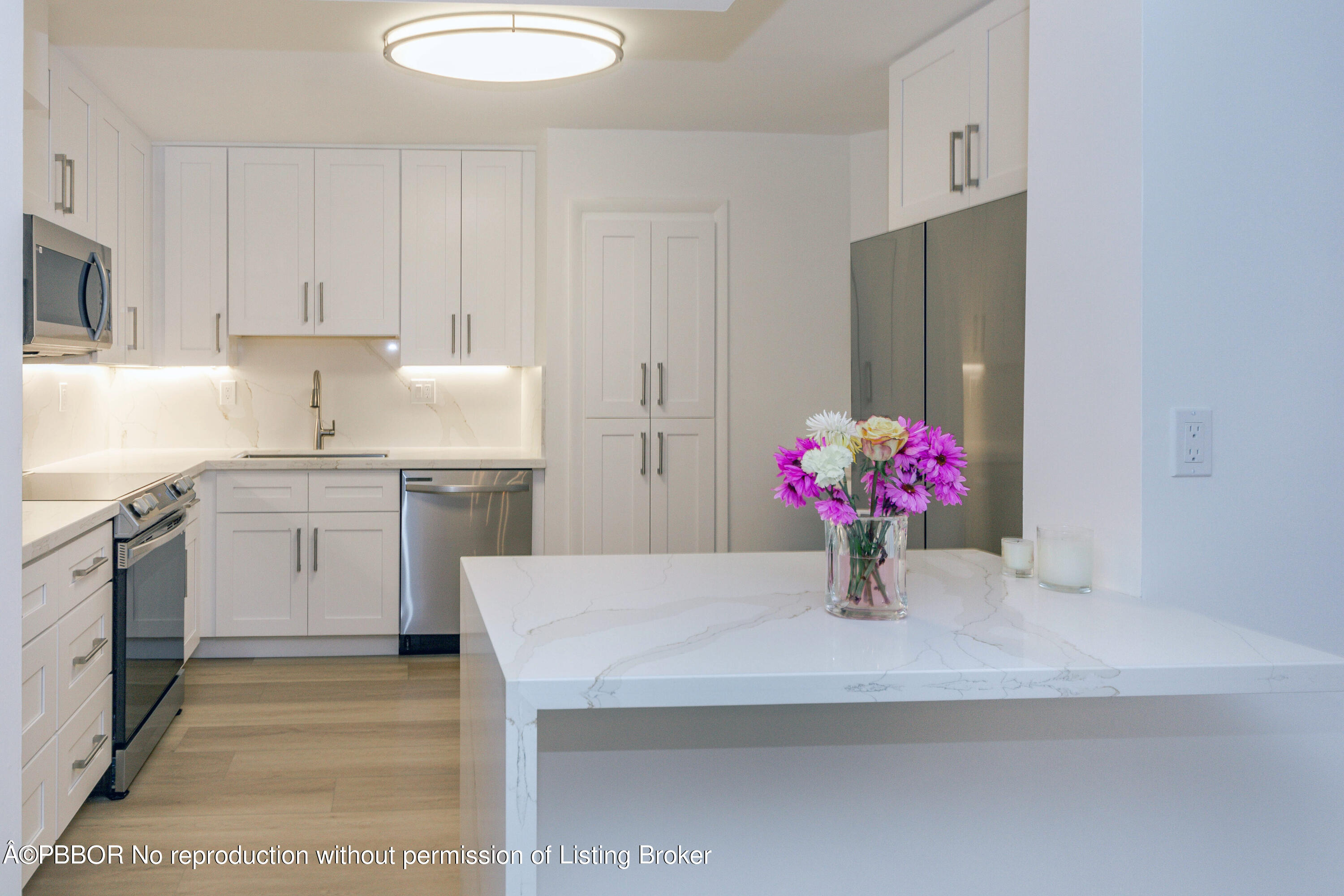 a kitchen with white cabinets and white appliances