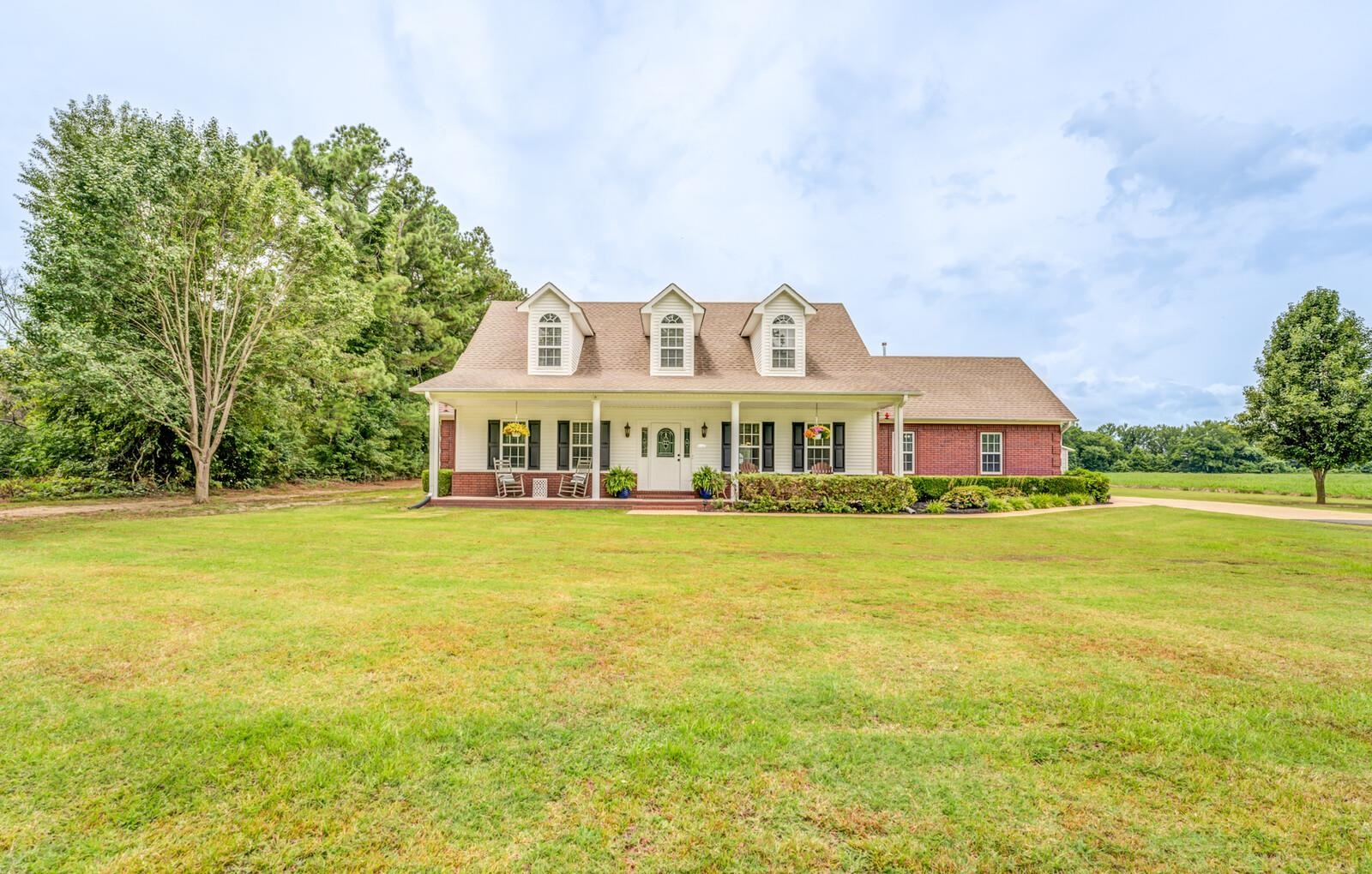 a front view of a house with a big yard