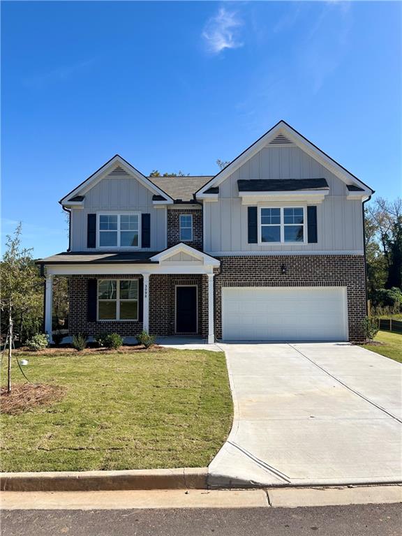 a front view of a house with yard and trees