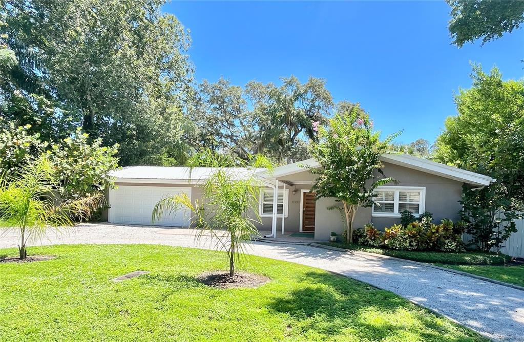 a house that has a tree in front of it