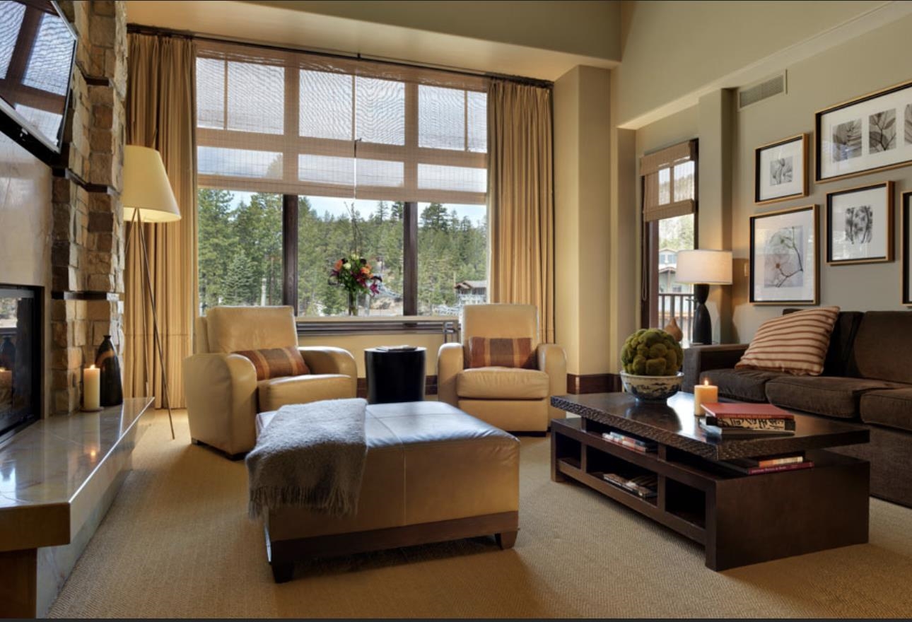 a living room with furniture and floor to ceiling windows