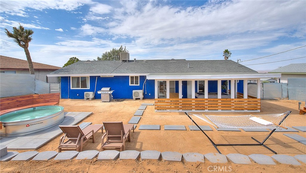 a view of a house with swimming pool and sitting area