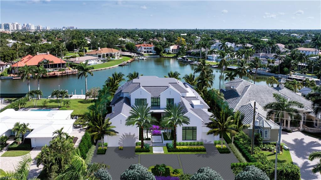 an aerial view of lake residential house with swimming pool and outdoor space