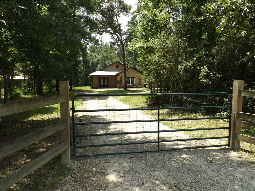 a view of backyard with wooden fence