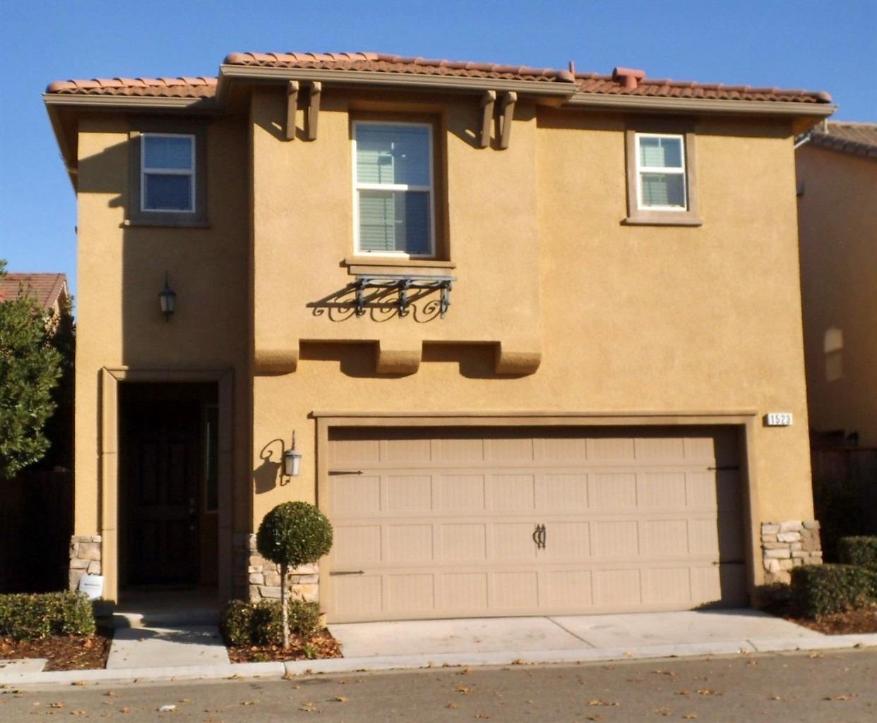 a front view of a house with a garage