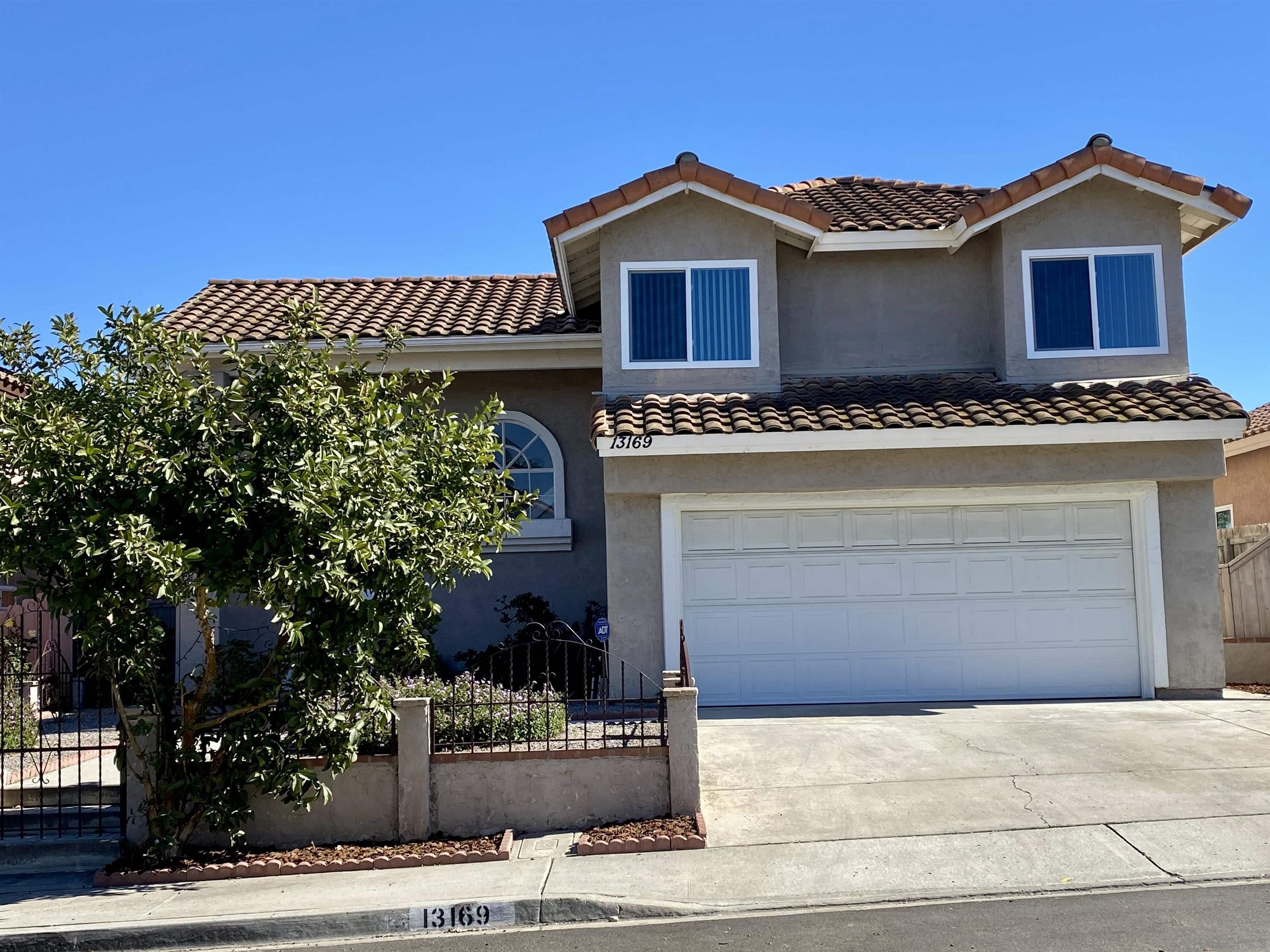 a front view of a house with a yard and garage