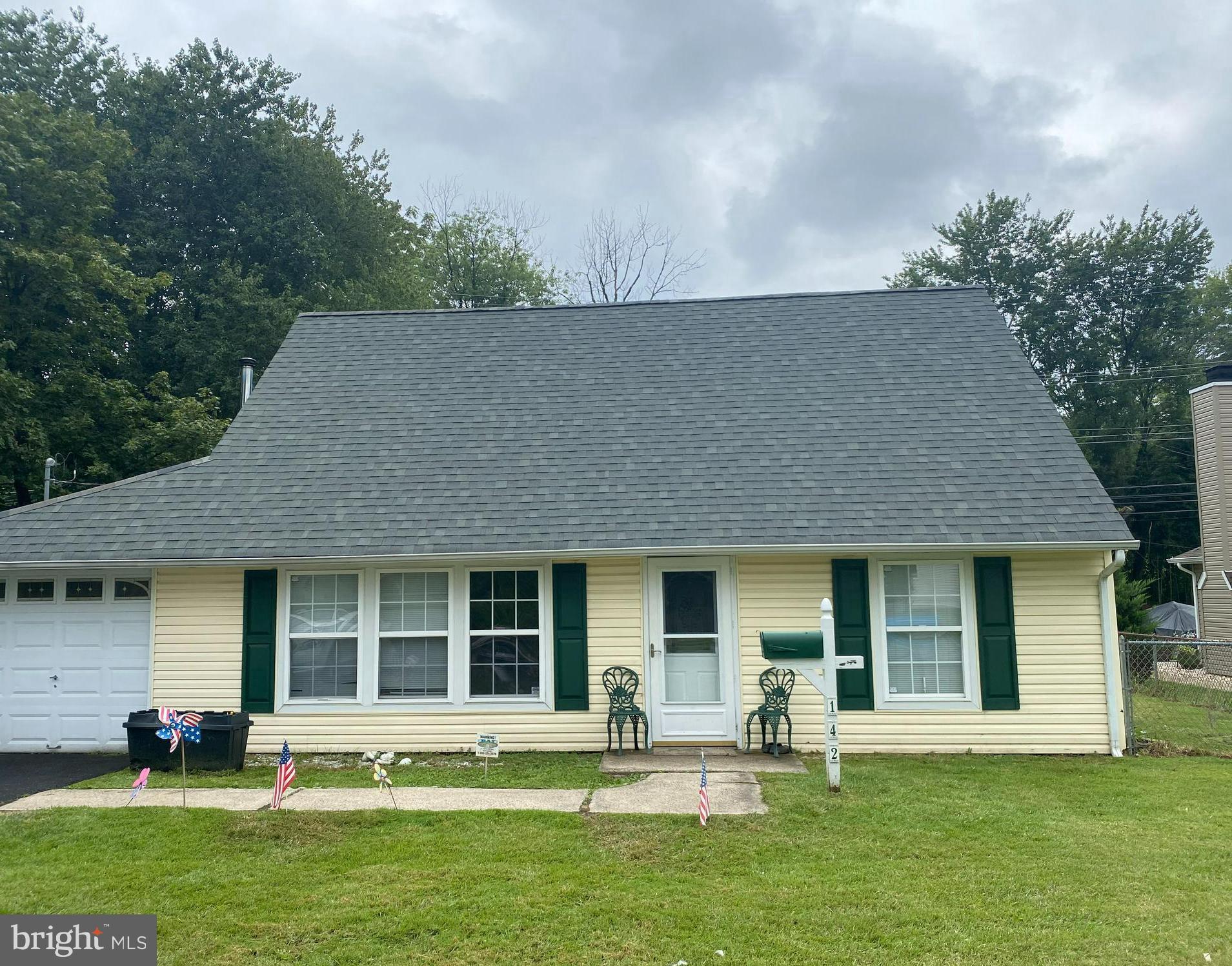 a front view of a house with a garden and porch