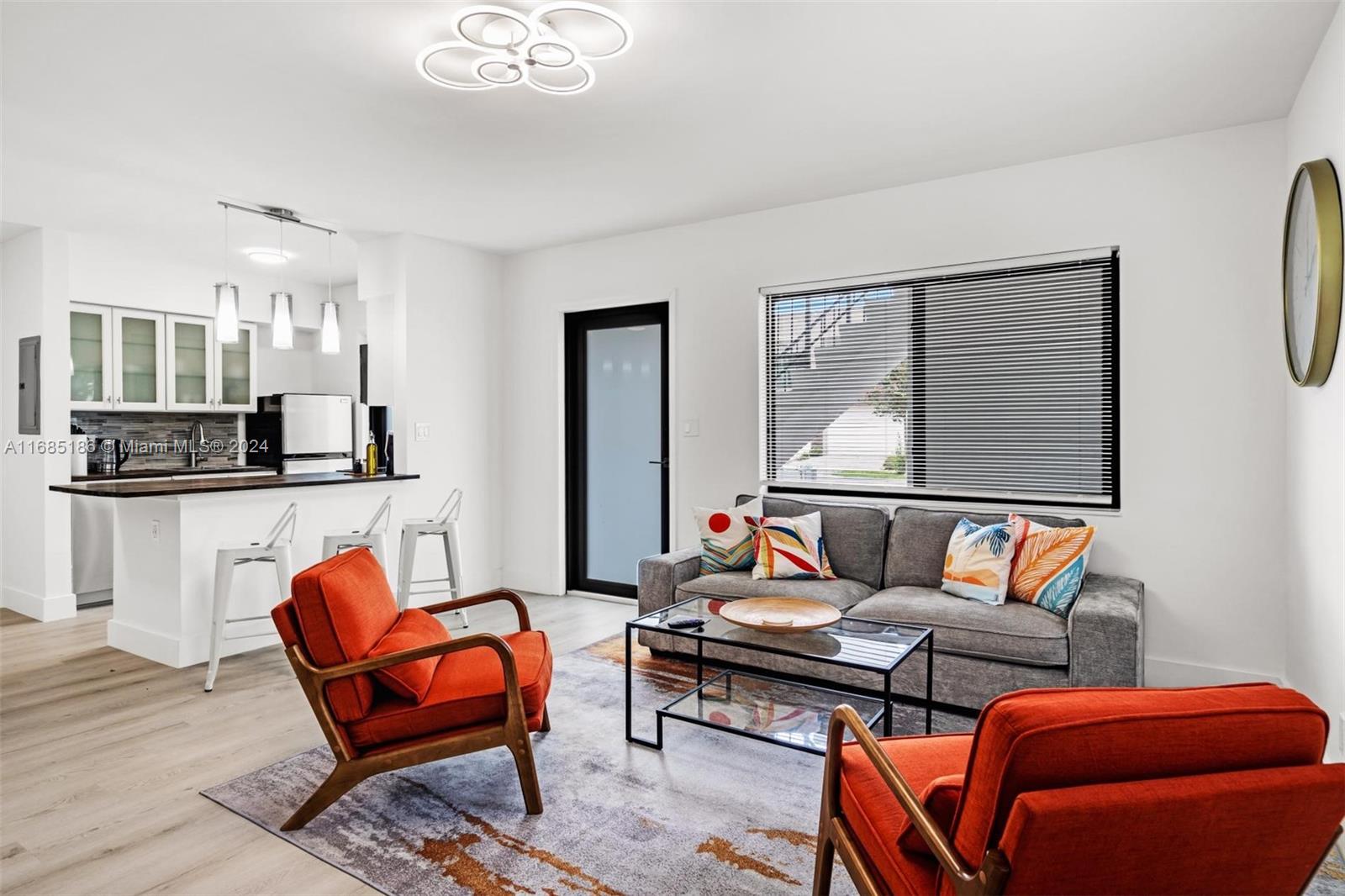 a living room with furniture and kitchen view