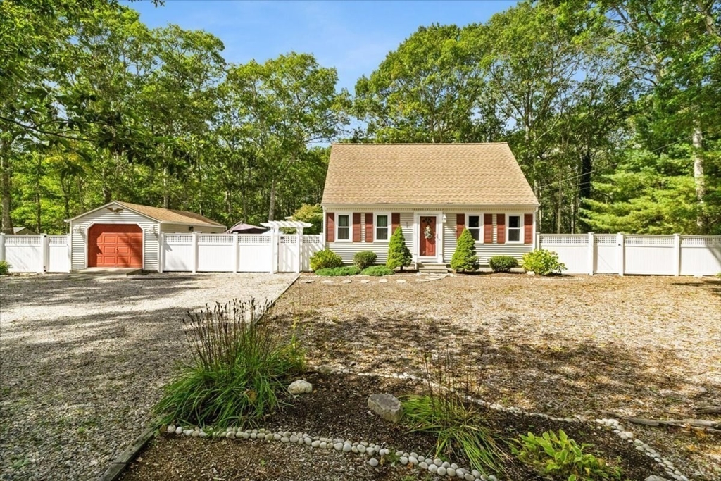 a view of a house with a yard and sitting area