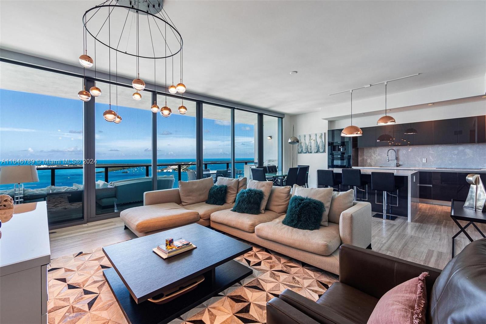 a living room with furniture a rug and a floor to ceiling window