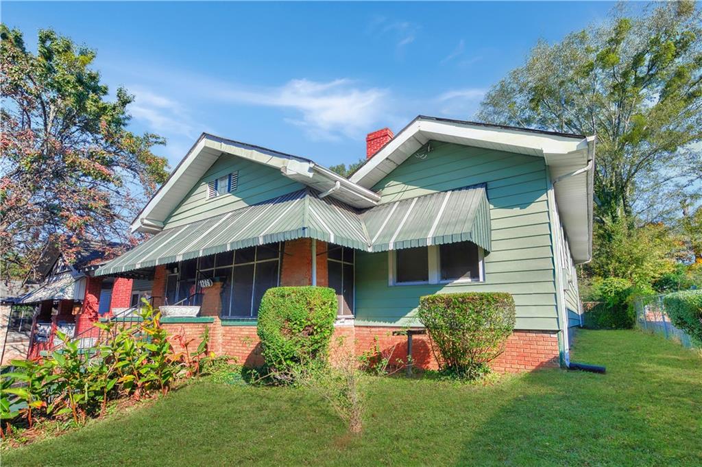 a front view of house with a garden