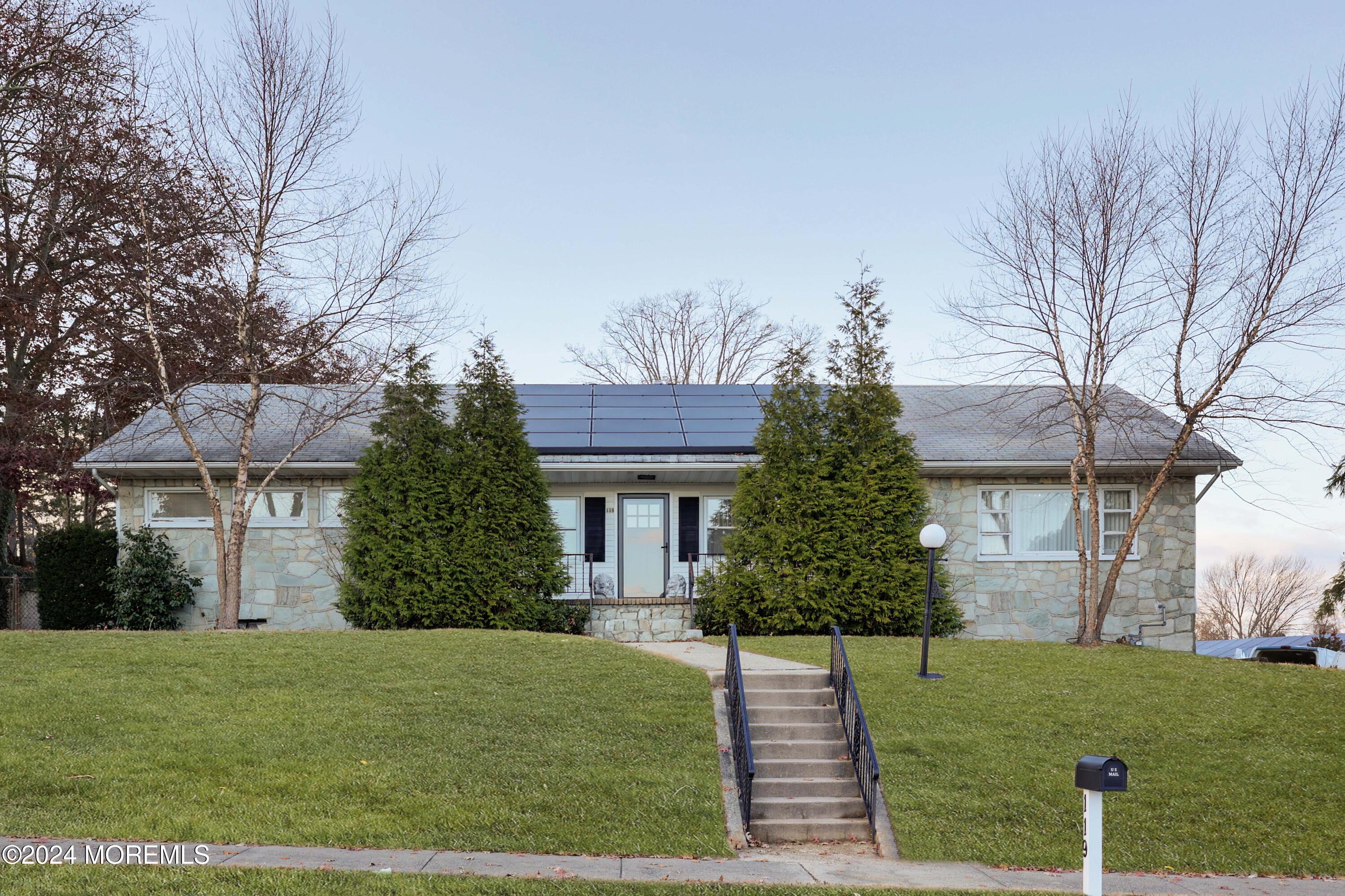 a front view of a house with a garden