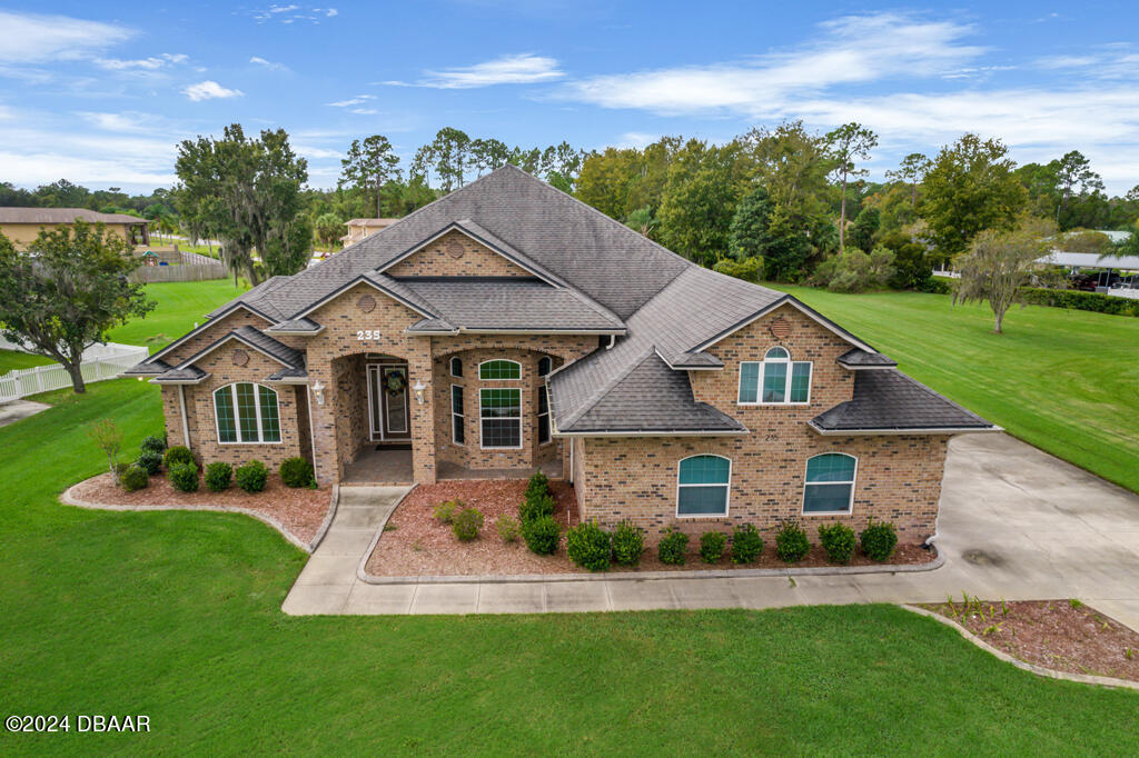 a front view of a house with a yard