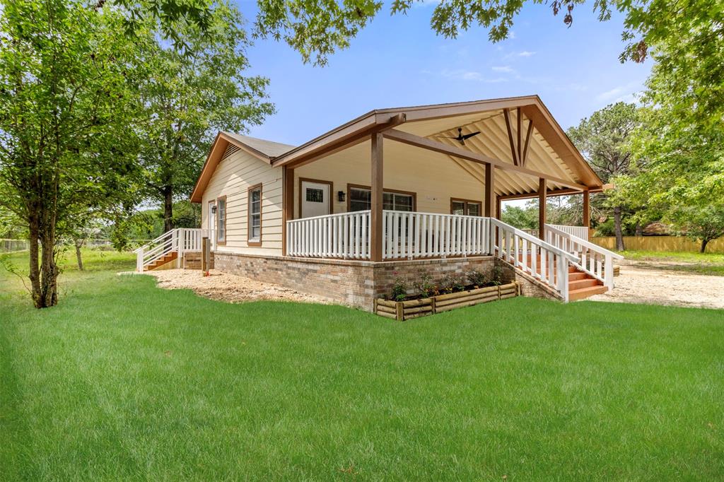 a view of a house with a yard and deck