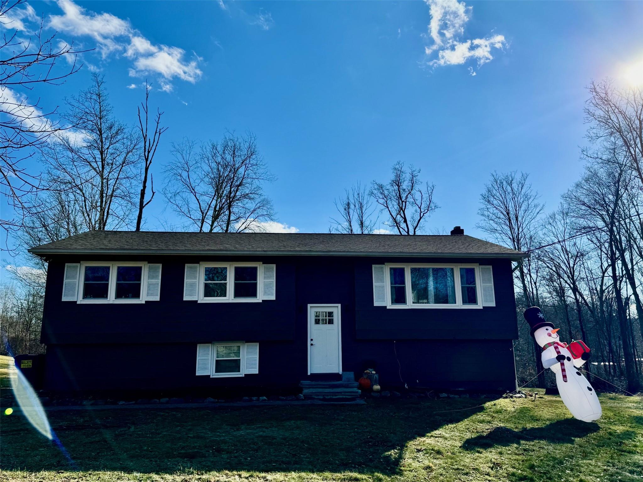 Split foyer home with a front yard