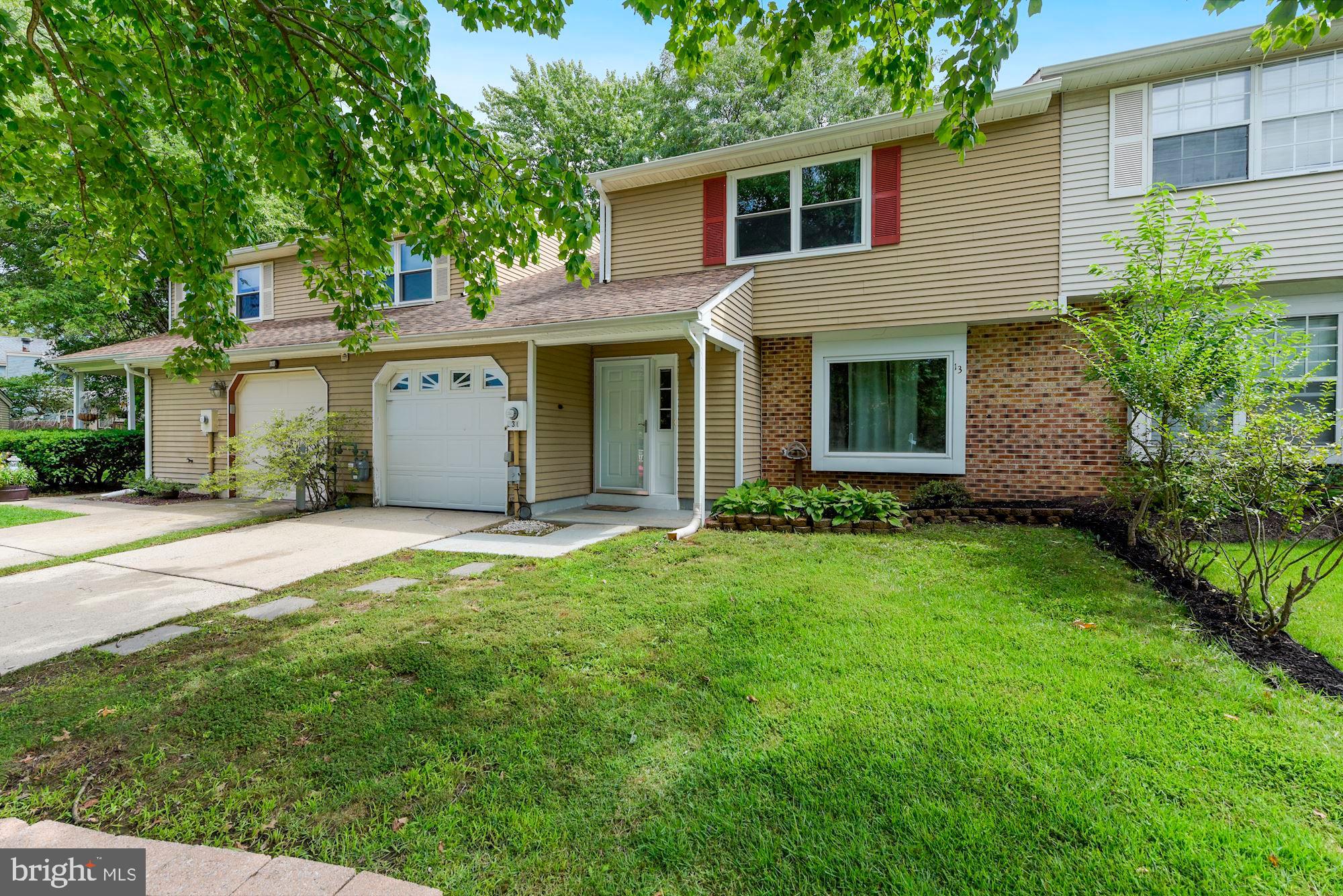 a view of a house with backyard and garden