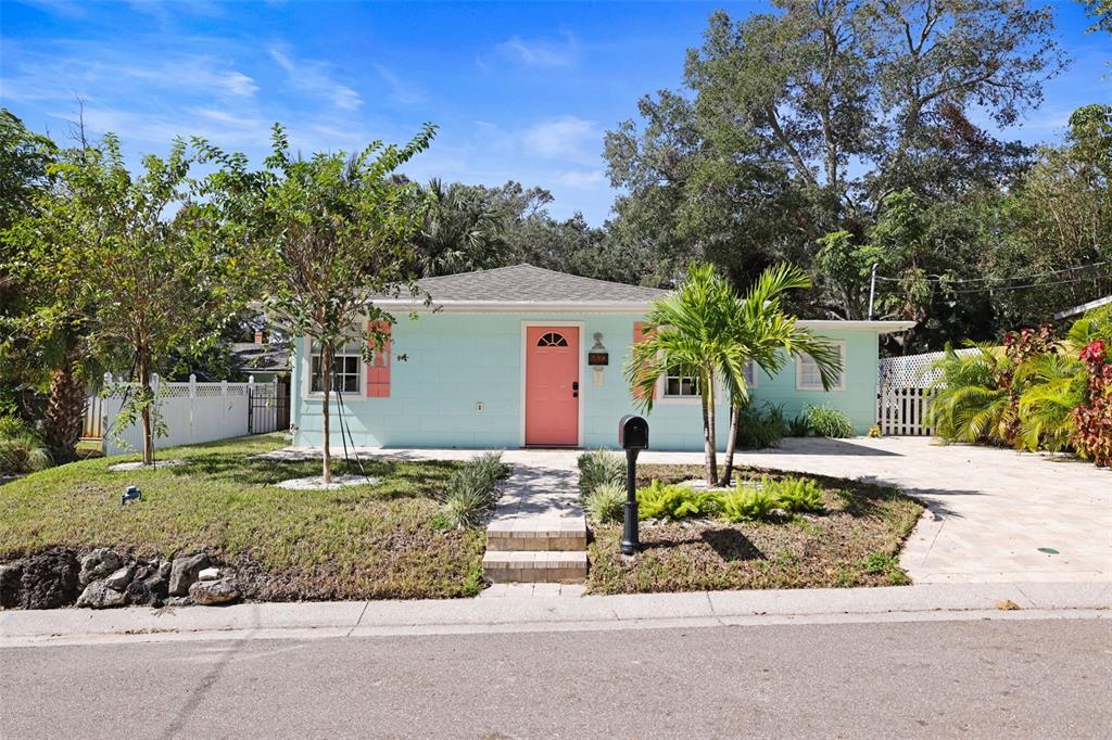 a front view of a house with a yard garage and outdoor seating