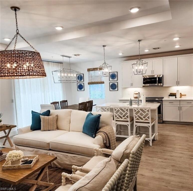 a living room with furniture and kitchen view