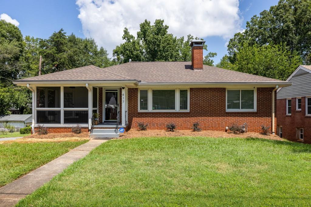 a view of a house with a yard and sitting area