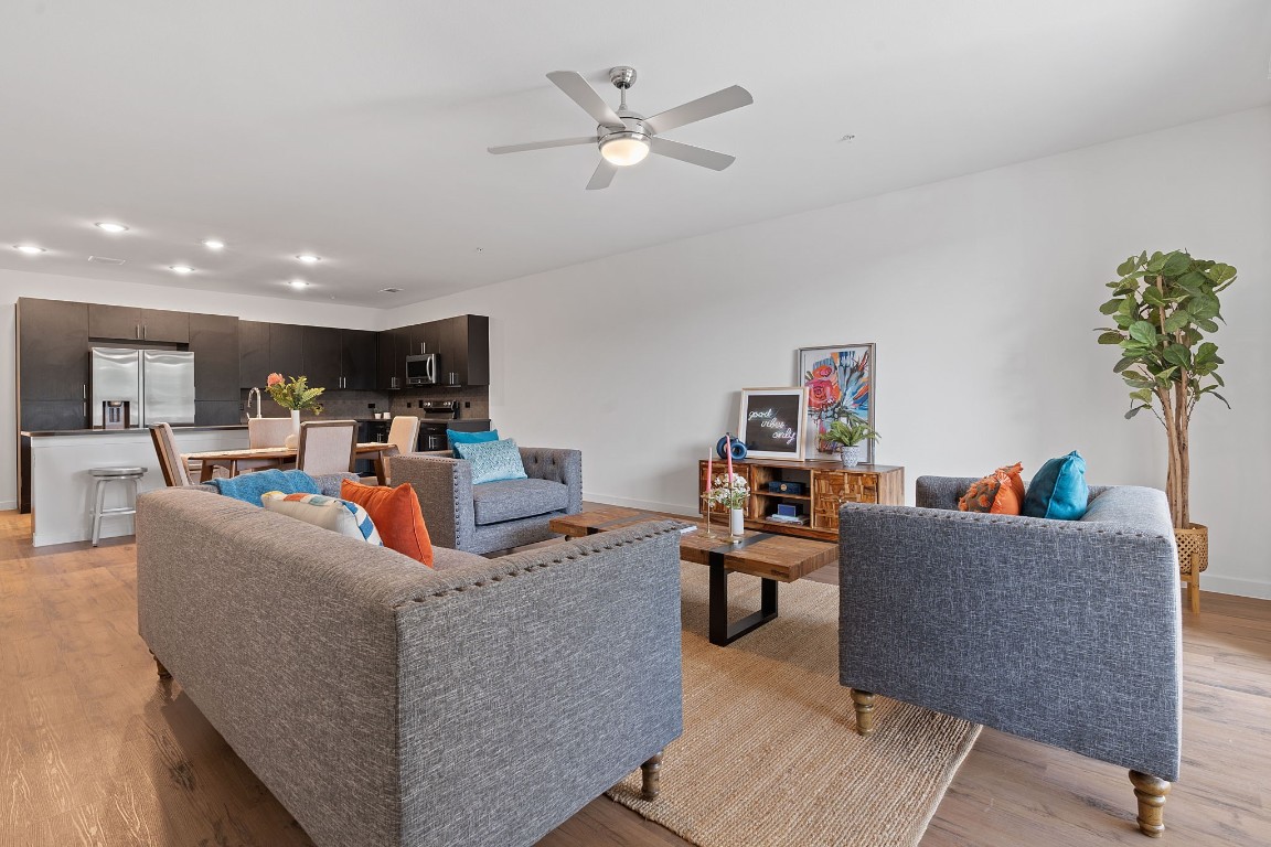 a living room with furniture and a ceiling fan