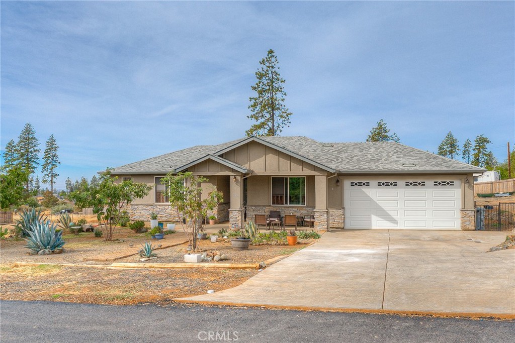 a front view of a house with basket ball court and a fire pit