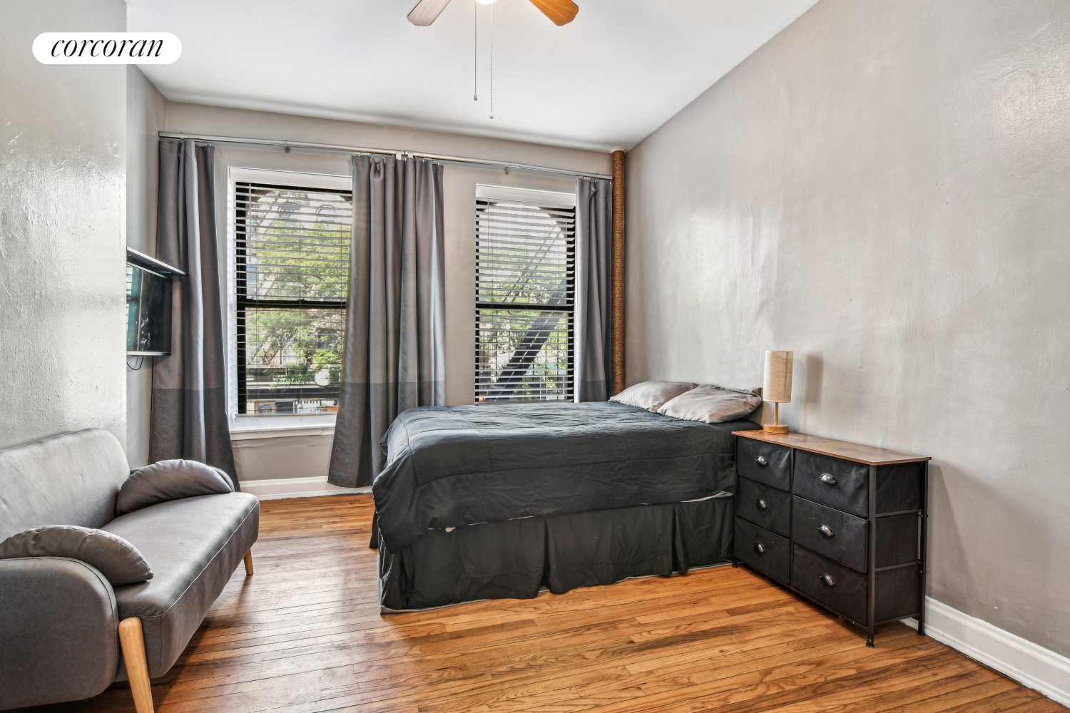 a bedroom with a bed and wooden floor