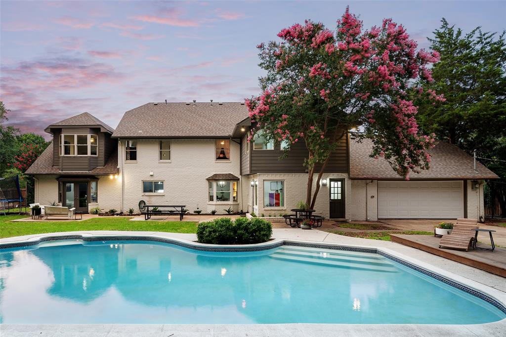 a house view with swimming pool and chairs