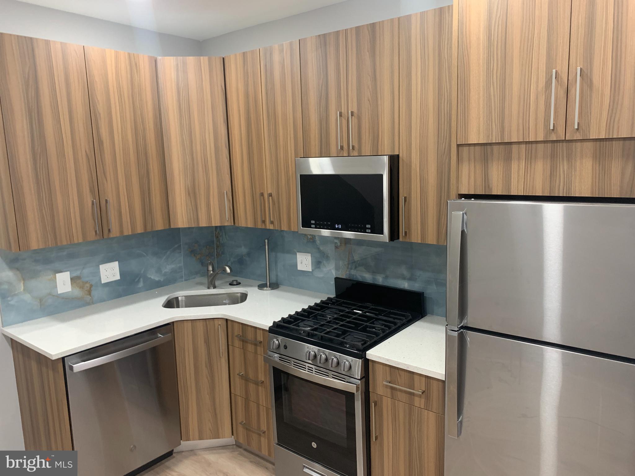 a kitchen with a stove and a refrigerator