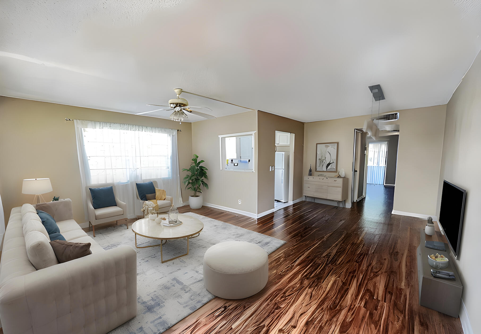 a living room with furniture and a wooden floor