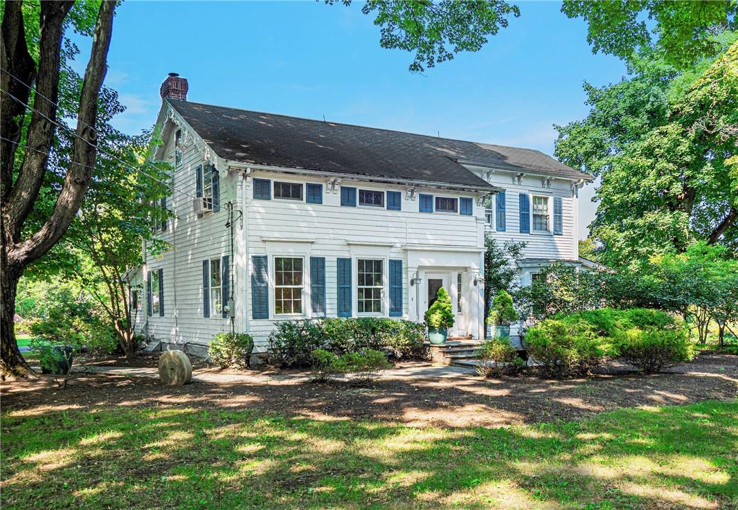 Colonial home with a front lawn