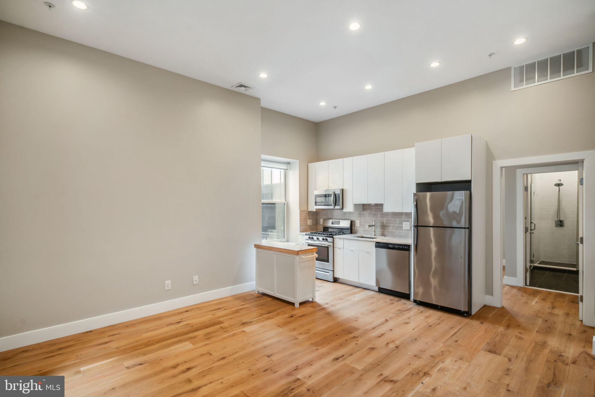 a kitchen with a refrigerator and a sink