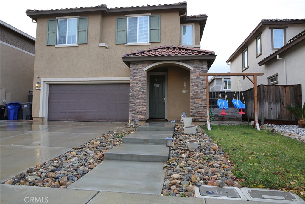 a front view of a house with garden