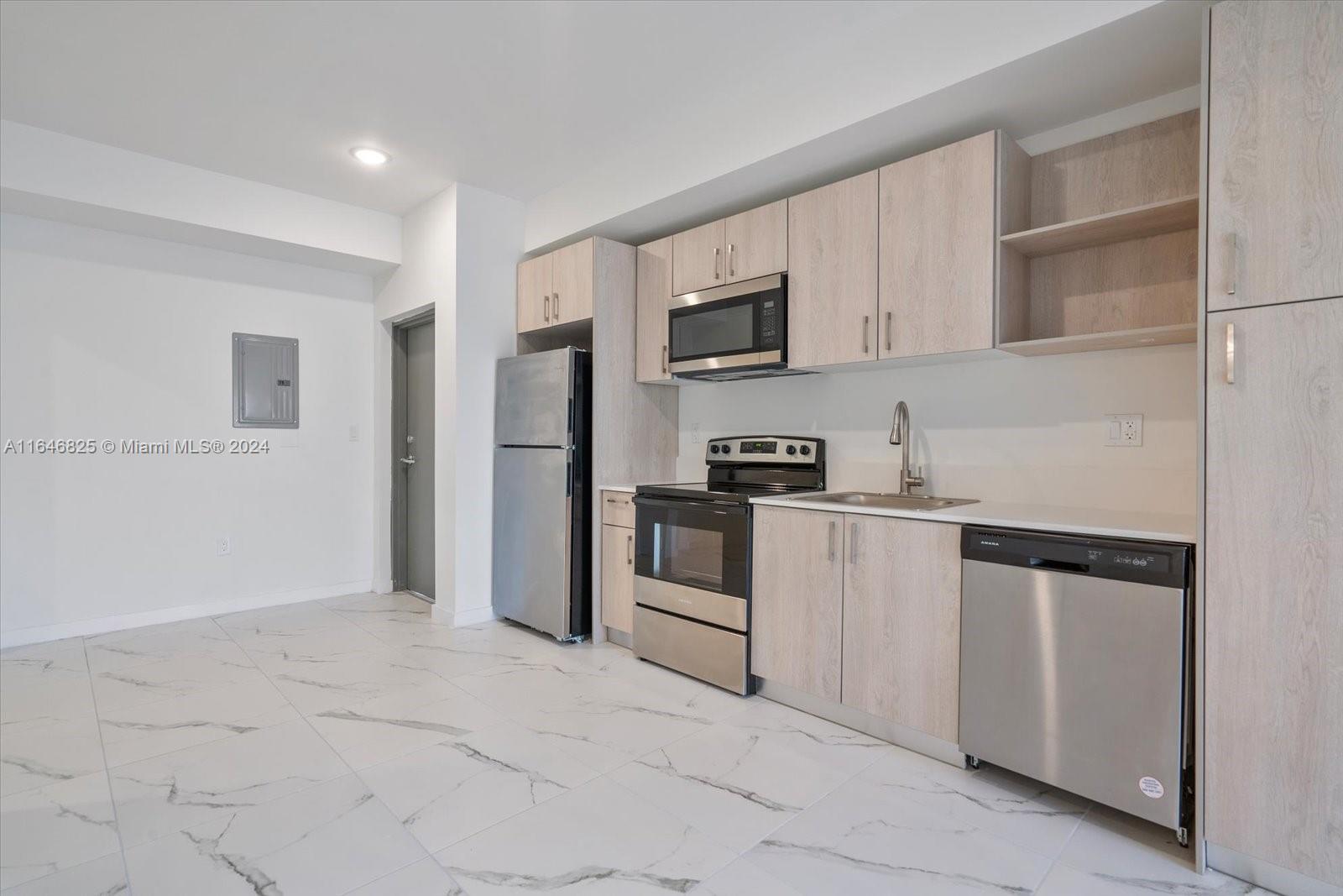 a kitchen with white cabinets and white appliances