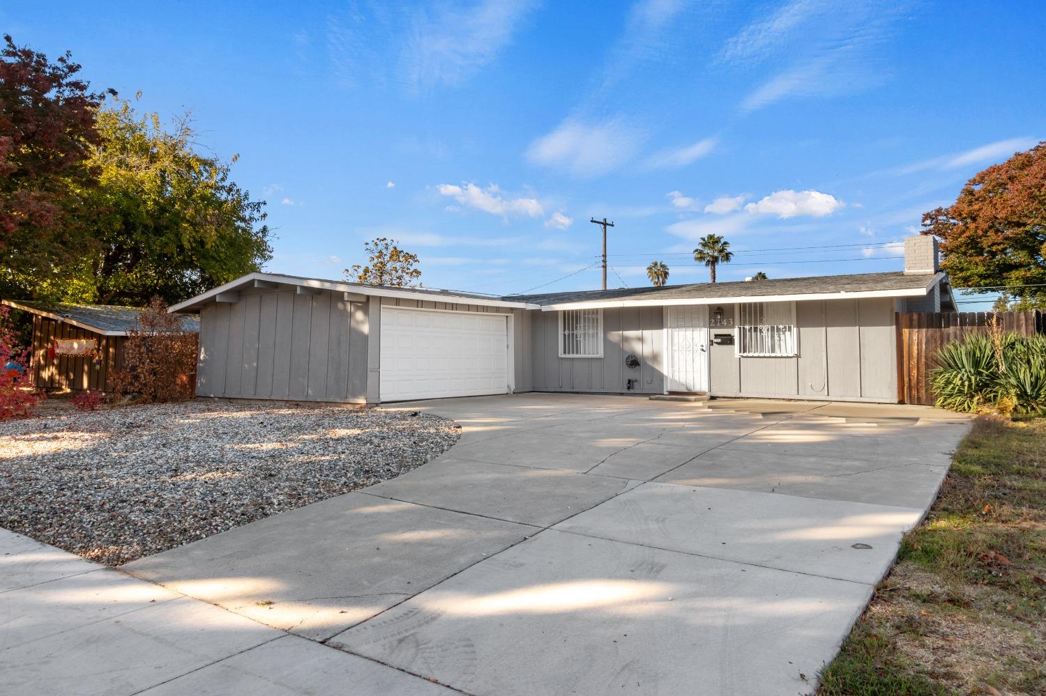 a view of a house with a yard and garage