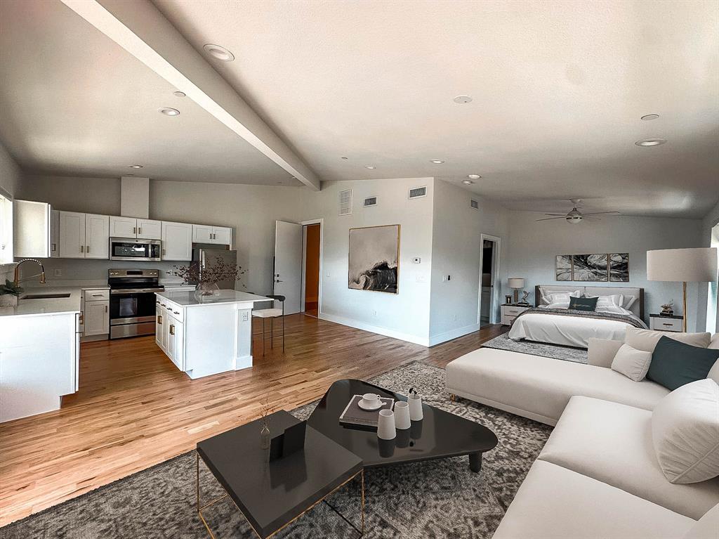 a living room with furniture and kitchen view