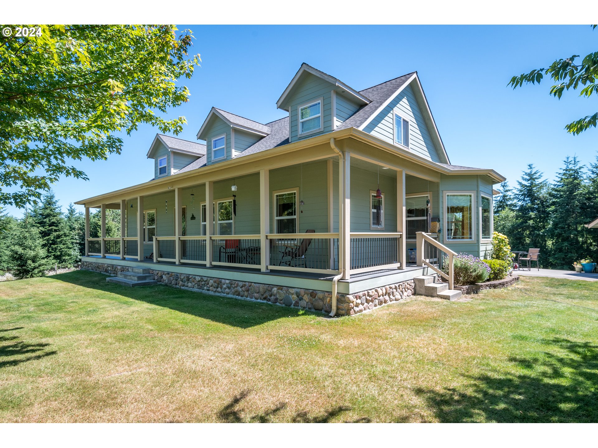 a view of a house with backyard porch and sitting area