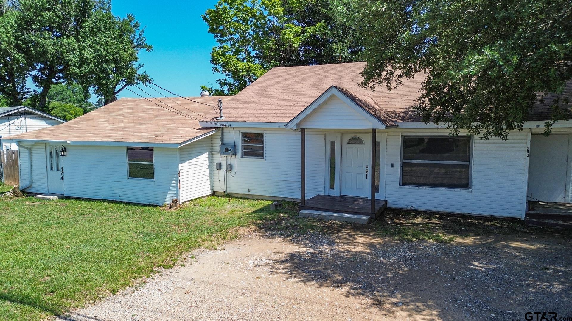 a house with lots of trees in the background